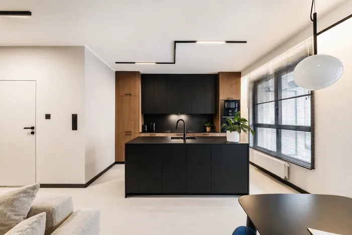 The same apartment with the navy sofa reupholstered in light oatmeal bouclé